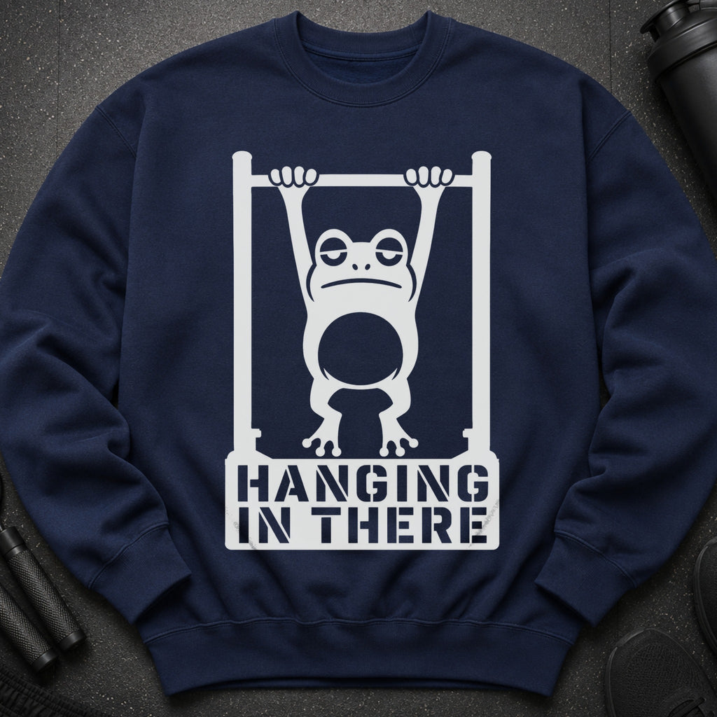 Navy sweatshirt with white graphic of a frog hanging from bars, saying "Hanging In There".