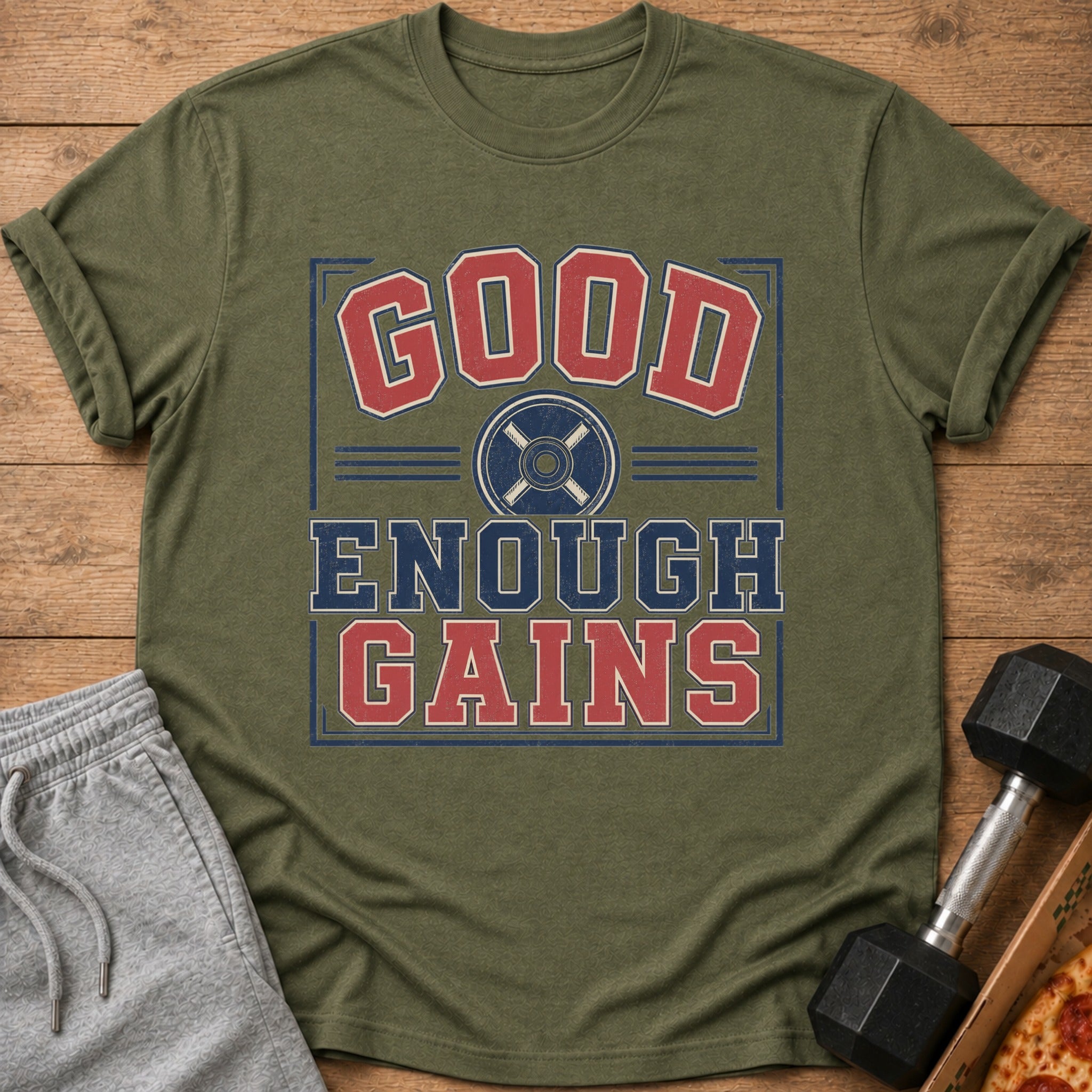 Olive green t-shirt with "GOOD ENOUGH GAINS" and weight plate graphic.