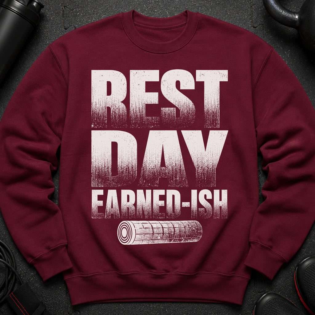 Maroon sweatshirt with "REST DAY EARNED-ISH" text and a rolled gym mat icon.