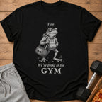 Black t-shirt with a frog in a hoodie holding a gym bag, text "Fine We're going to the GYM".