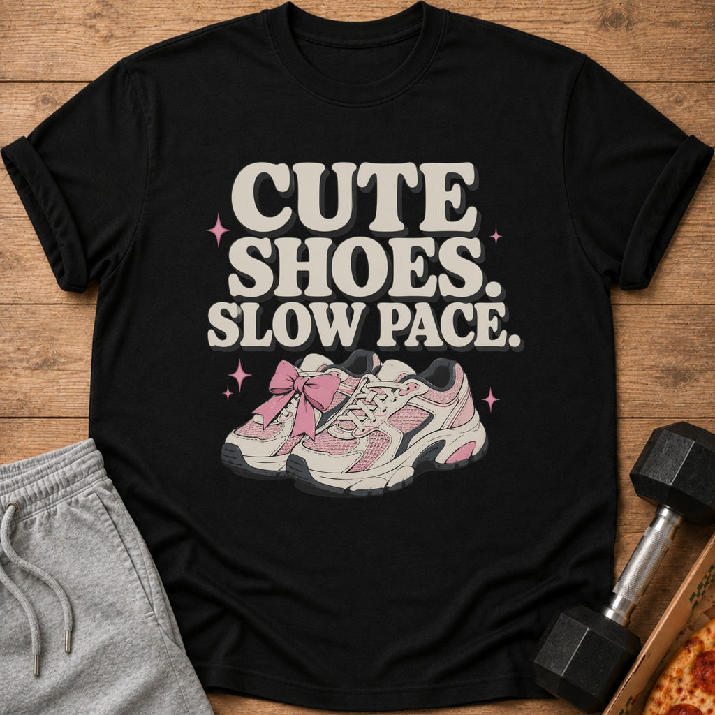 Black t-shirt with "Cute Shoes. Slow Pace." text and pink sneakers.