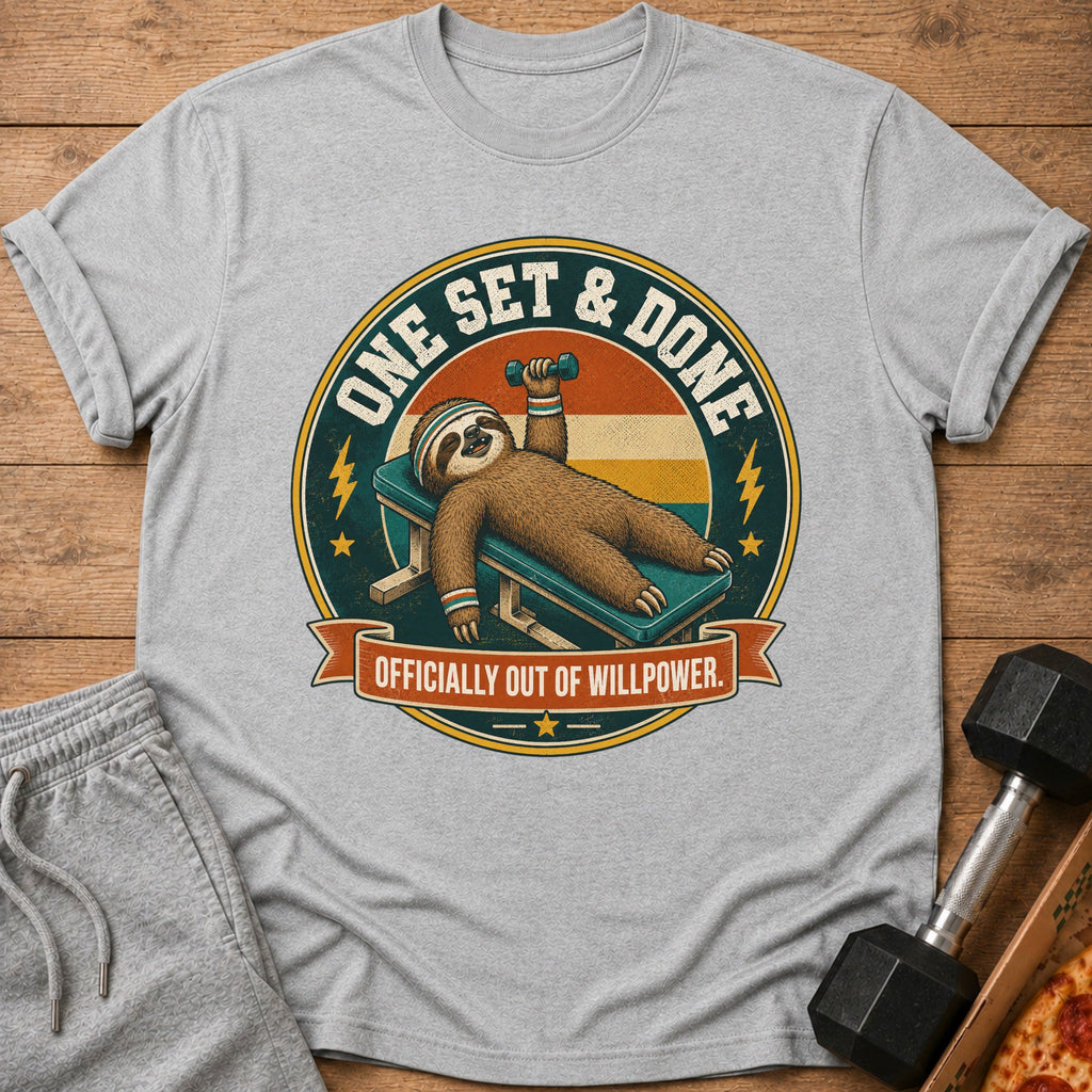 Gray t-shirt graphic of a sloth lying on a bench press, holding a dumbbell.