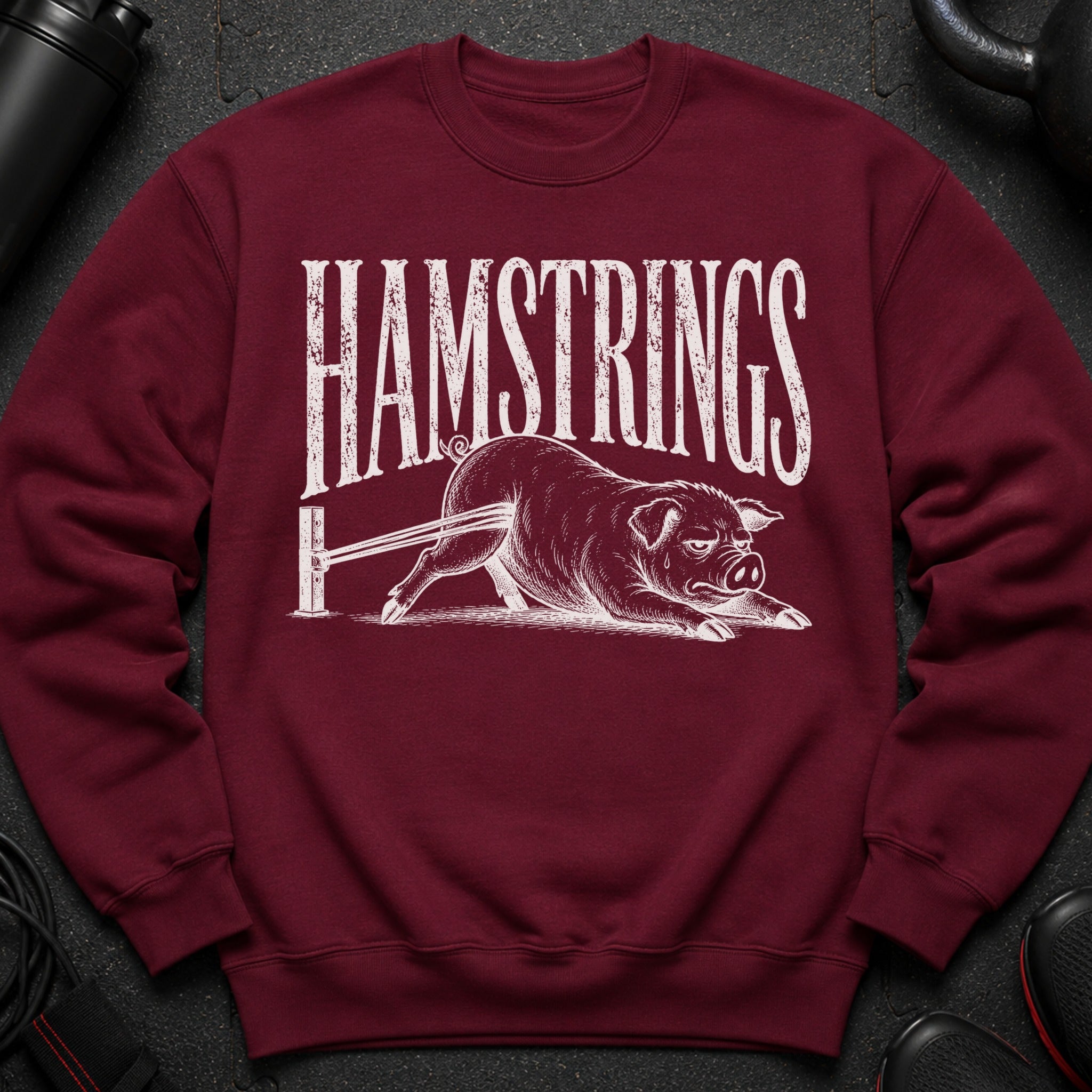 Maroon sweatshirt with "HAMSTRINGS" text and a drawing of a pig.