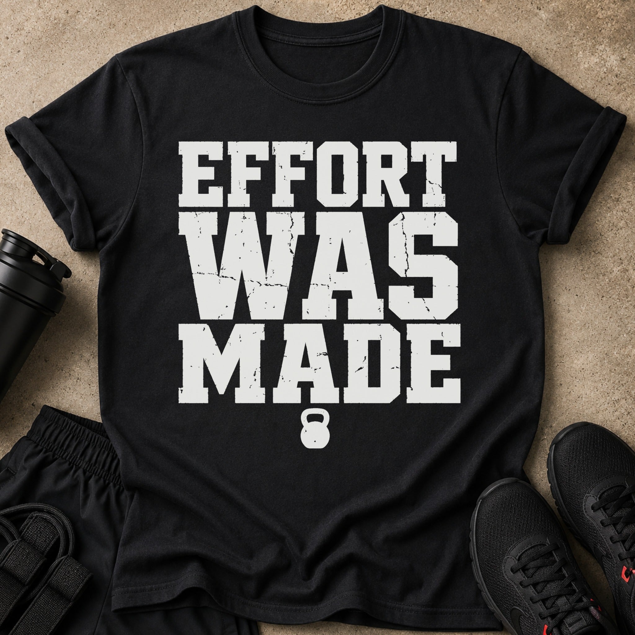 Black t-shirt with white distressed text "EFFORT WAS MADE" and a kettlebell icon.