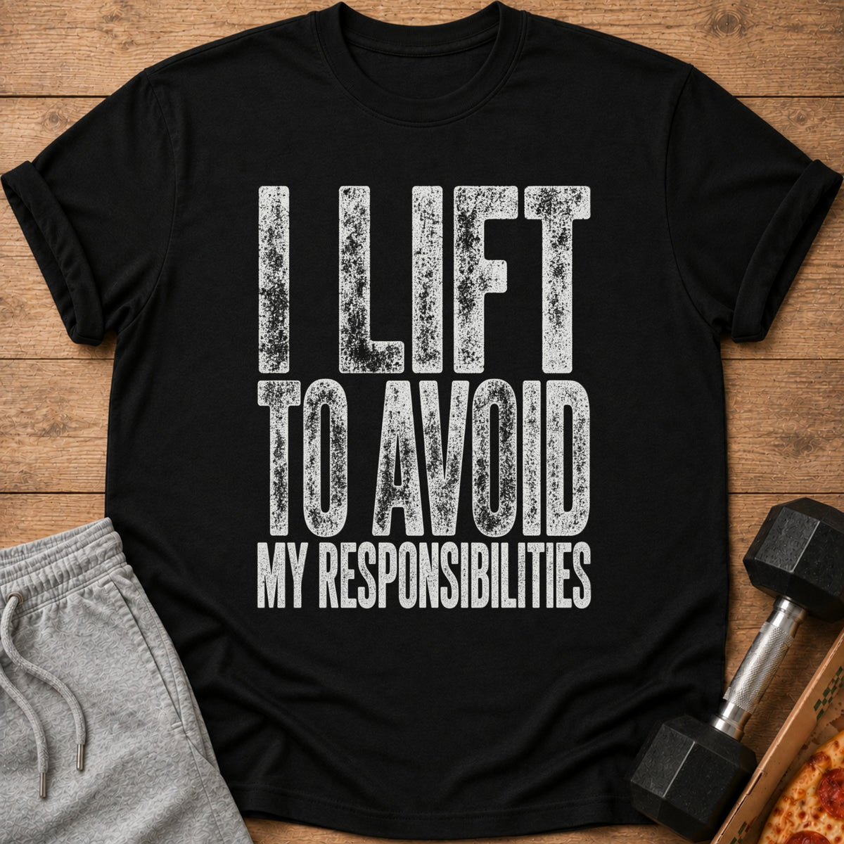Black t-shirt with white text reading "I LIFT TO AVOID MY RESPONSIBILITIES".