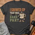 T-shirt with "I showed up that was the hard part" text and a tired coffee cup lifting dumbbell.