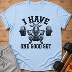 Light blue t-shirt with graphic of a goat squatting with a barbell and text "I HAVE ONE GOOD SET".