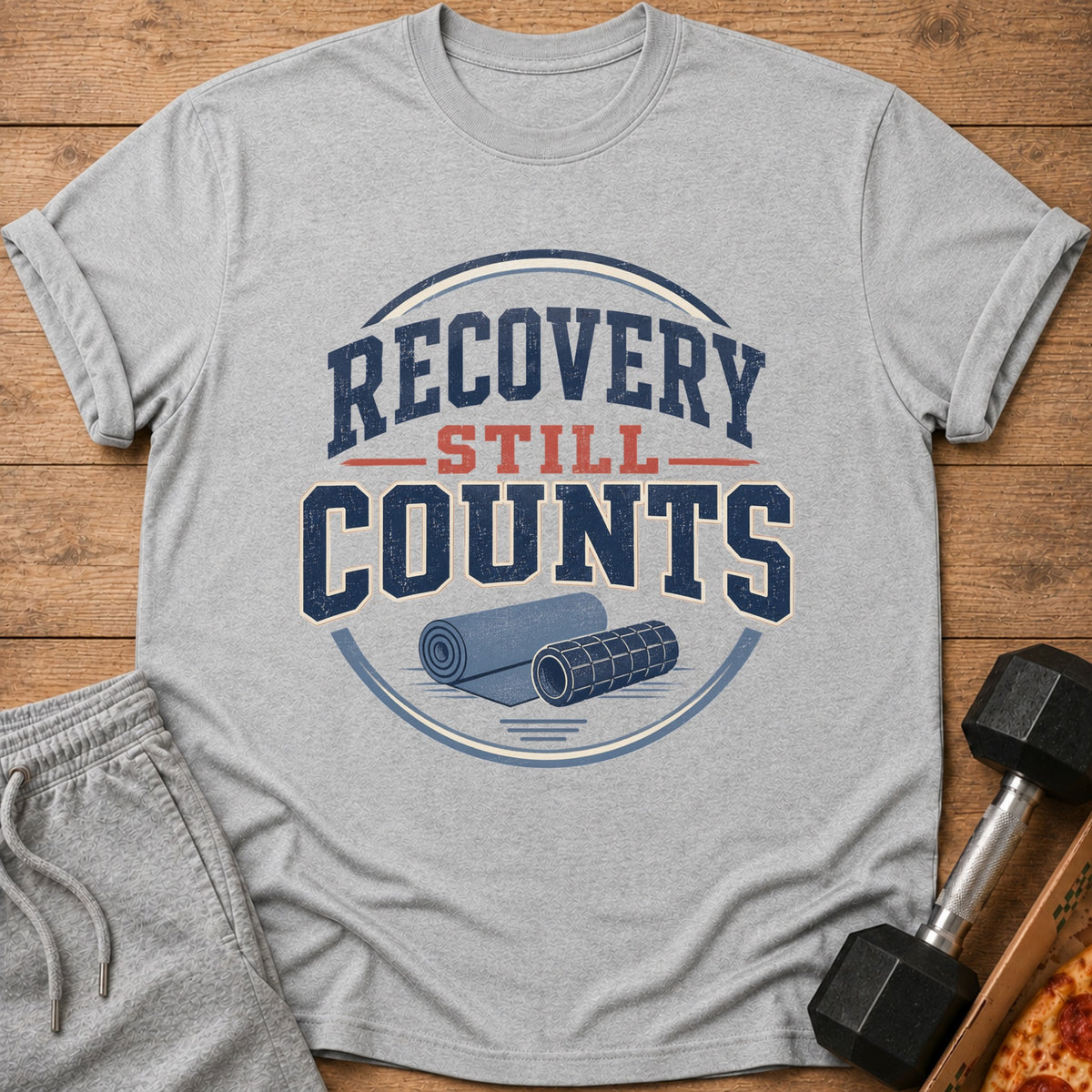 Gray t-shirt with "Recovery Still Counts" text and rolled yoga mats.
