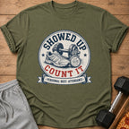 Olive green t-shirt with "Showed Up Count It" graphic featuring dumbbell, shoe, and stopwatch.