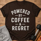 Brown t-shirt with "POWERED BY COFFEE & REGRET" text, shorts, dumbbell, and pizza.