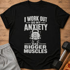 Black t-shirt featuring distressed white text that reads I WORK OUT SO MY ANXIETY HAS BIGGER MUSCLES.