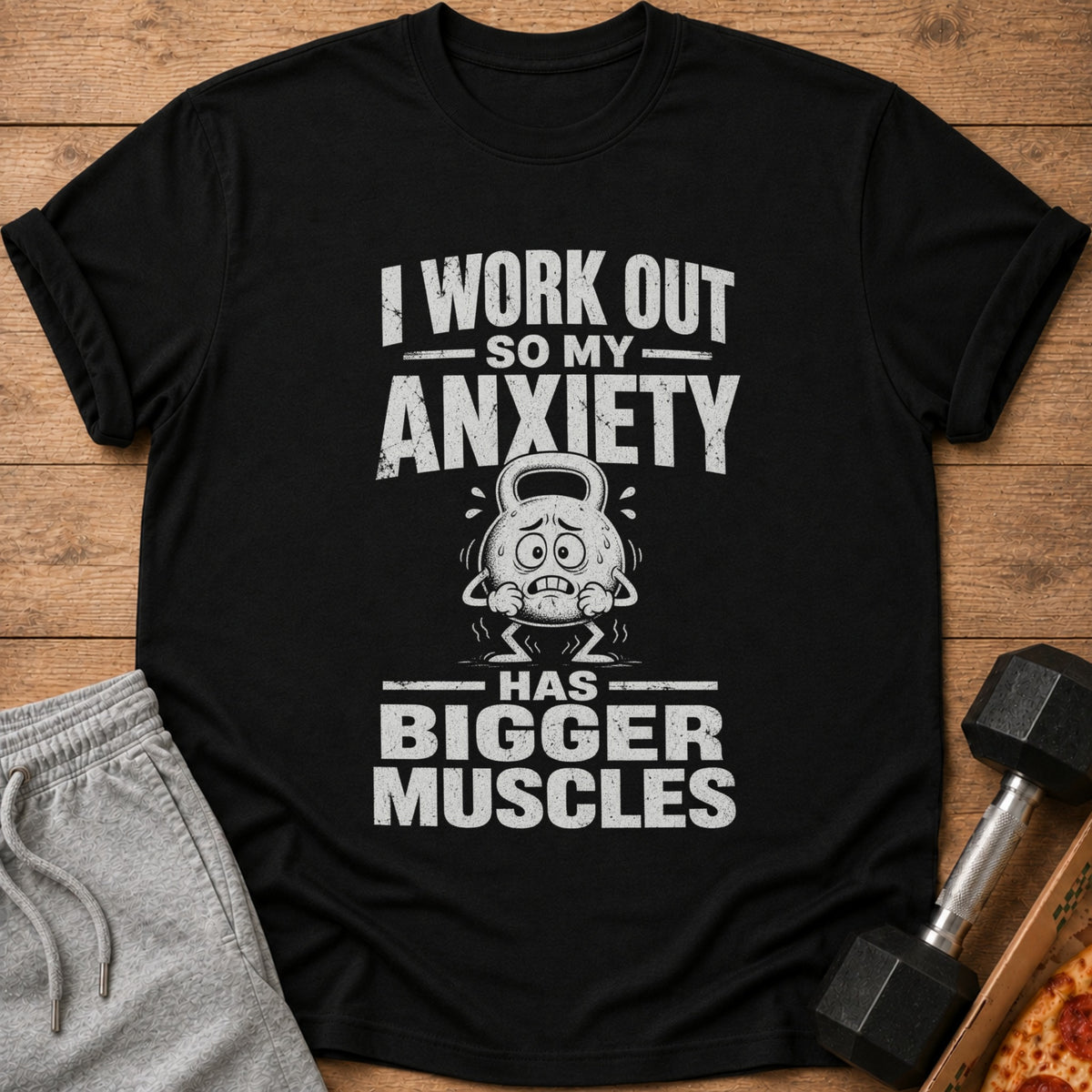 Black t-shirt featuring distressed white text that reads I WORK OUT SO MY ANXIETY HAS BIGGER MUSCLES.