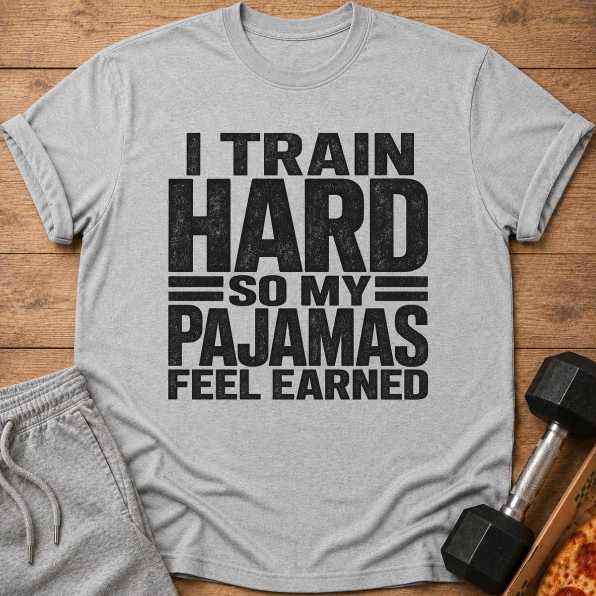Gray t-shirt with black text: "I TRAIN HARD SO MY PAJAMAS FEEL EARNED".