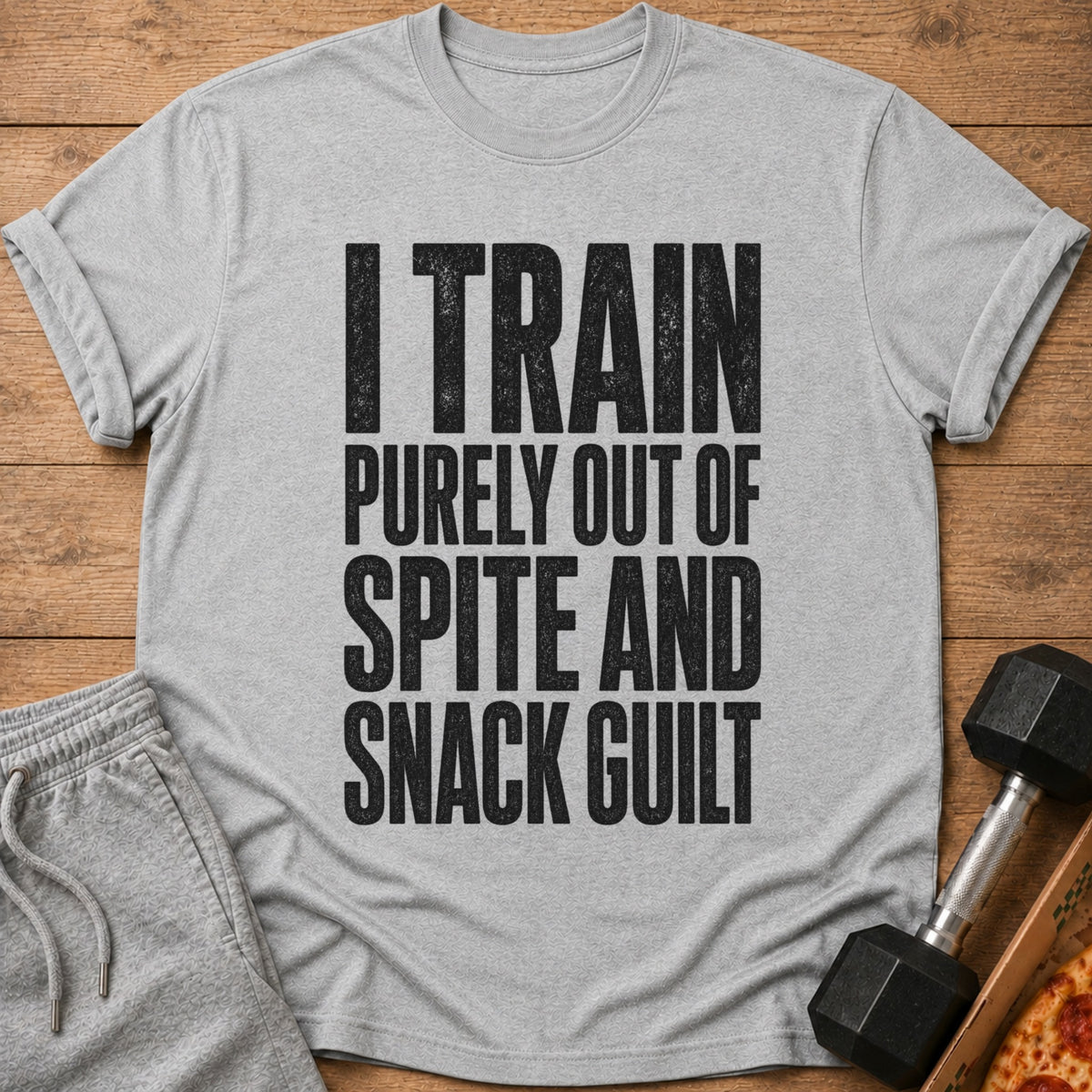 Grey t-shirt with black text: "I TRAIN PURELY OUT OF SPITE AND SNACK GUILT".