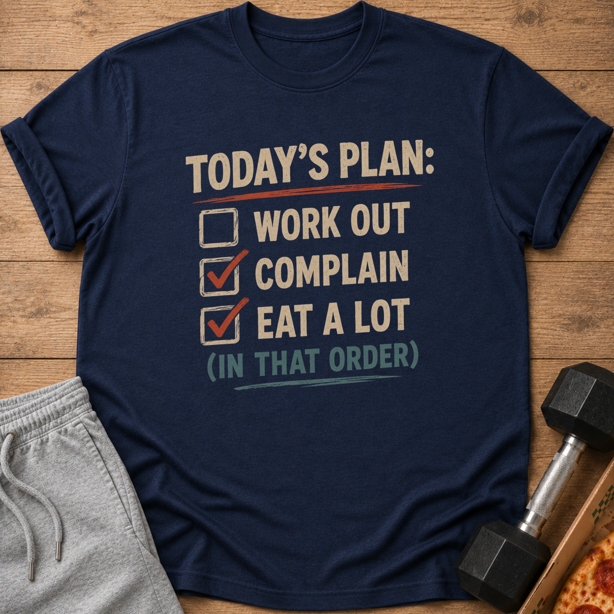 Navy t-shirt with text: "TODAY'S PLAN: WORK OUT, COMPLAIN, EAT A LOT (IN THAT ORDER)".