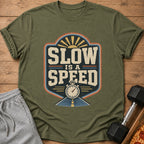 Green t-shirt with "SLOW IS A SPEED" graphic, stopwatch, and sun.