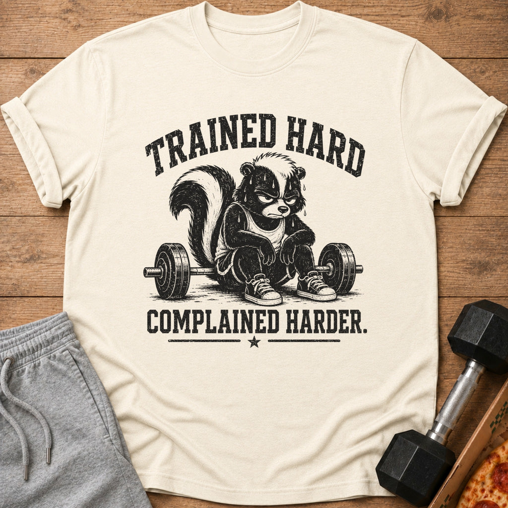 T-shirt with skunk character sitting by barbell and text "TRAINED HARD COMPLAINED HARDER."