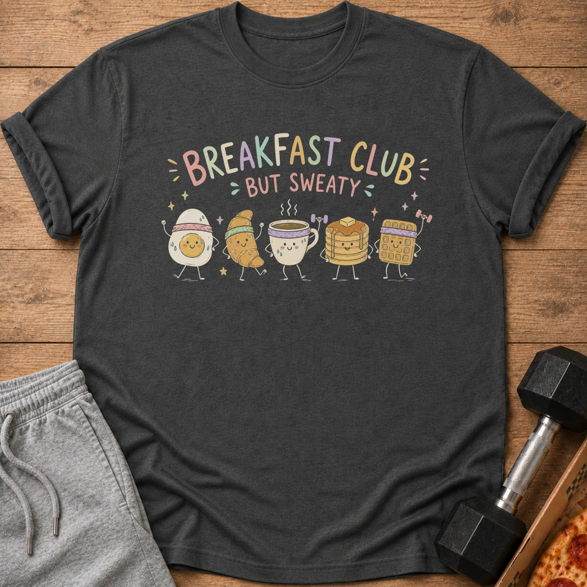 Dark grey t-shirt with "Breakfast Club But Sweaty" text and cartoon breakfast foods.