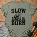 T-shirt with black text "SLOW BURN" and a snail lifting weights.
