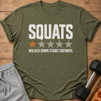 Olive green t-shirt with "SQUATS WALKED DOWN STAIRS SIDEWAYS." text.