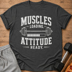 Dark gray t-shirt with "Muscles Loading. Attitude Ready." text and barbell graphic.