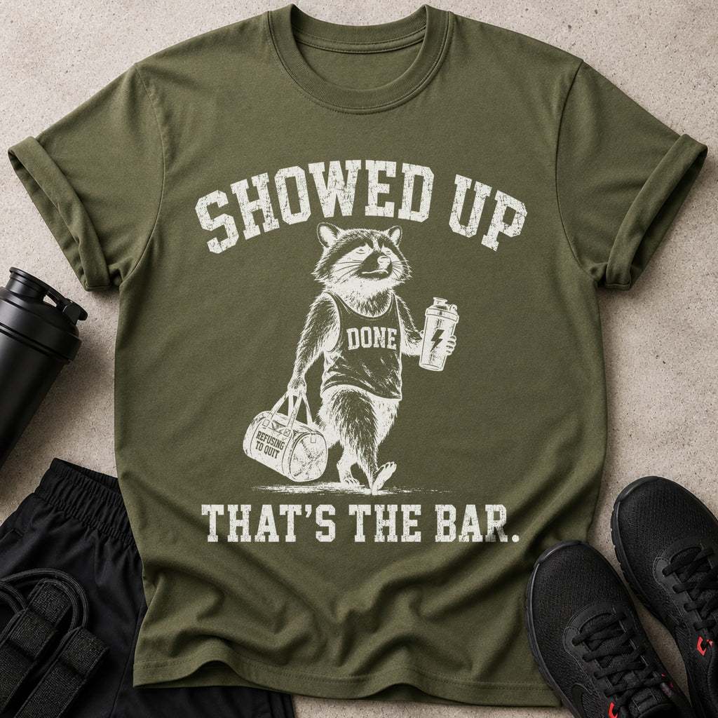 T-shirt with raccoon and text: "SHOWED UP, DONE, REFUSING TO QUIT, THAT'S THE BAR."