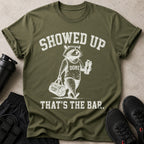 T-shirt with raccoon and text: "SHOWED UP, DONE, REFUSING TO QUIT, THAT'S THE BAR."