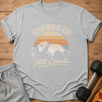 Grey t-shirt with panda and text "SHOWED UP Still Counts" and sun graphic.