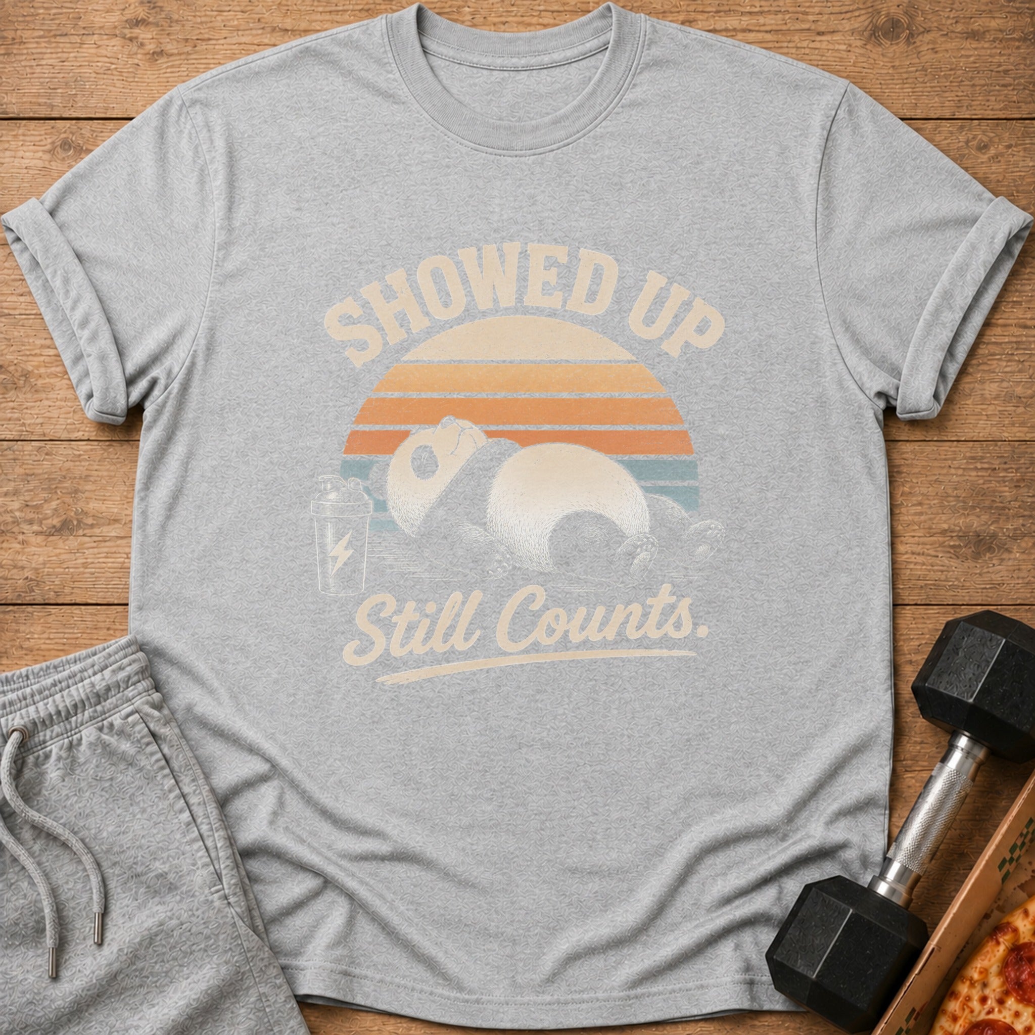 Grey t-shirt with panda and text "SHOWED UP Still Counts" and sun graphic.