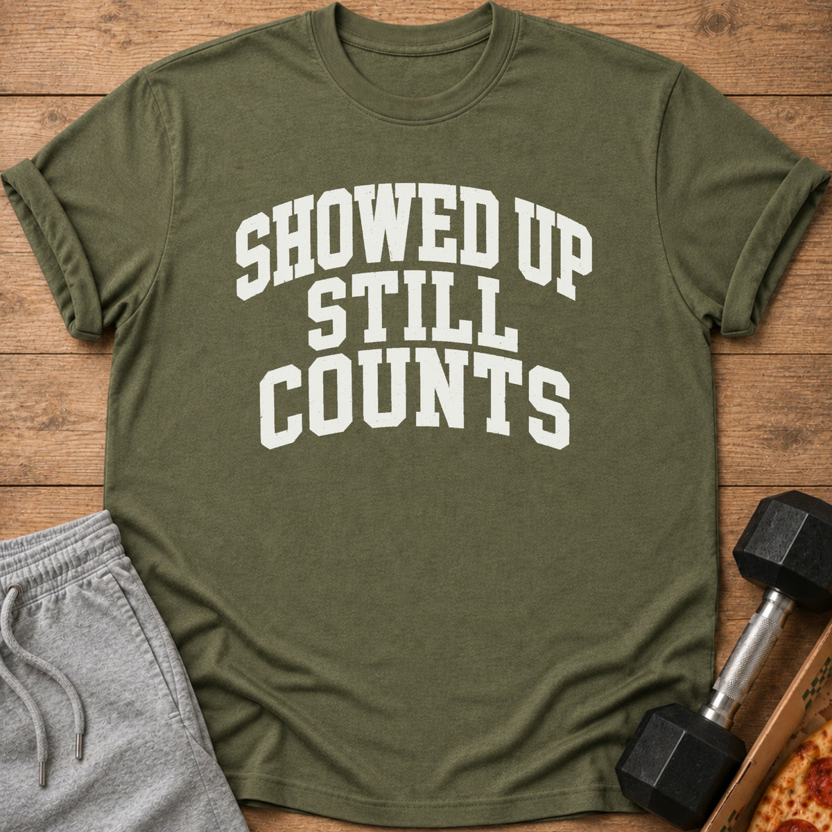 Green t-shirt with white text that reads "SHOWED UP STILL COUNTS".
