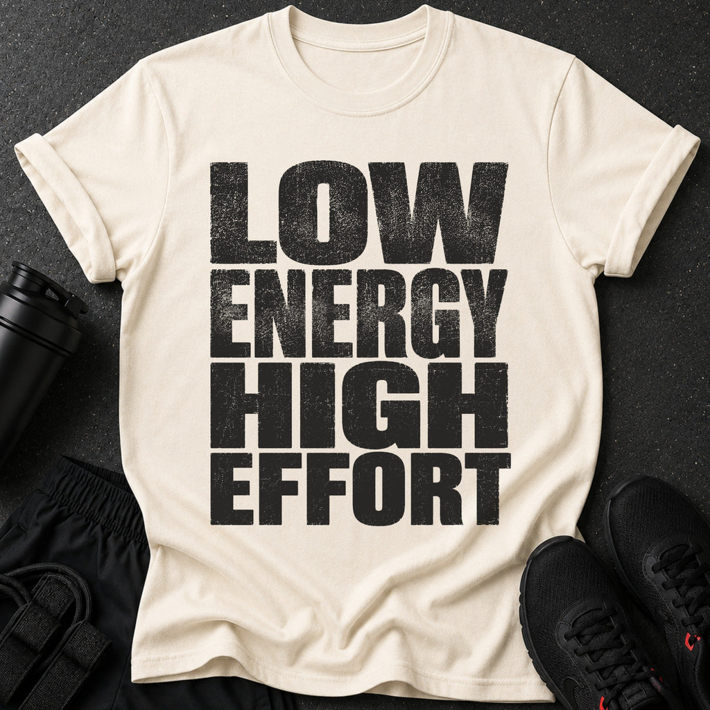 Cream t-shirt with black text "LOW ENERGY HIGH EFFORT" and workout gear.