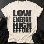 Cream t-shirt with black text "LOW ENERGY HIGH EFFORT" and workout gear.