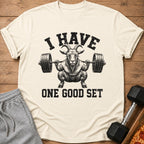 Cream t-shirt with goat lifting barbell and text "I HAVE ONE GOOD SET".