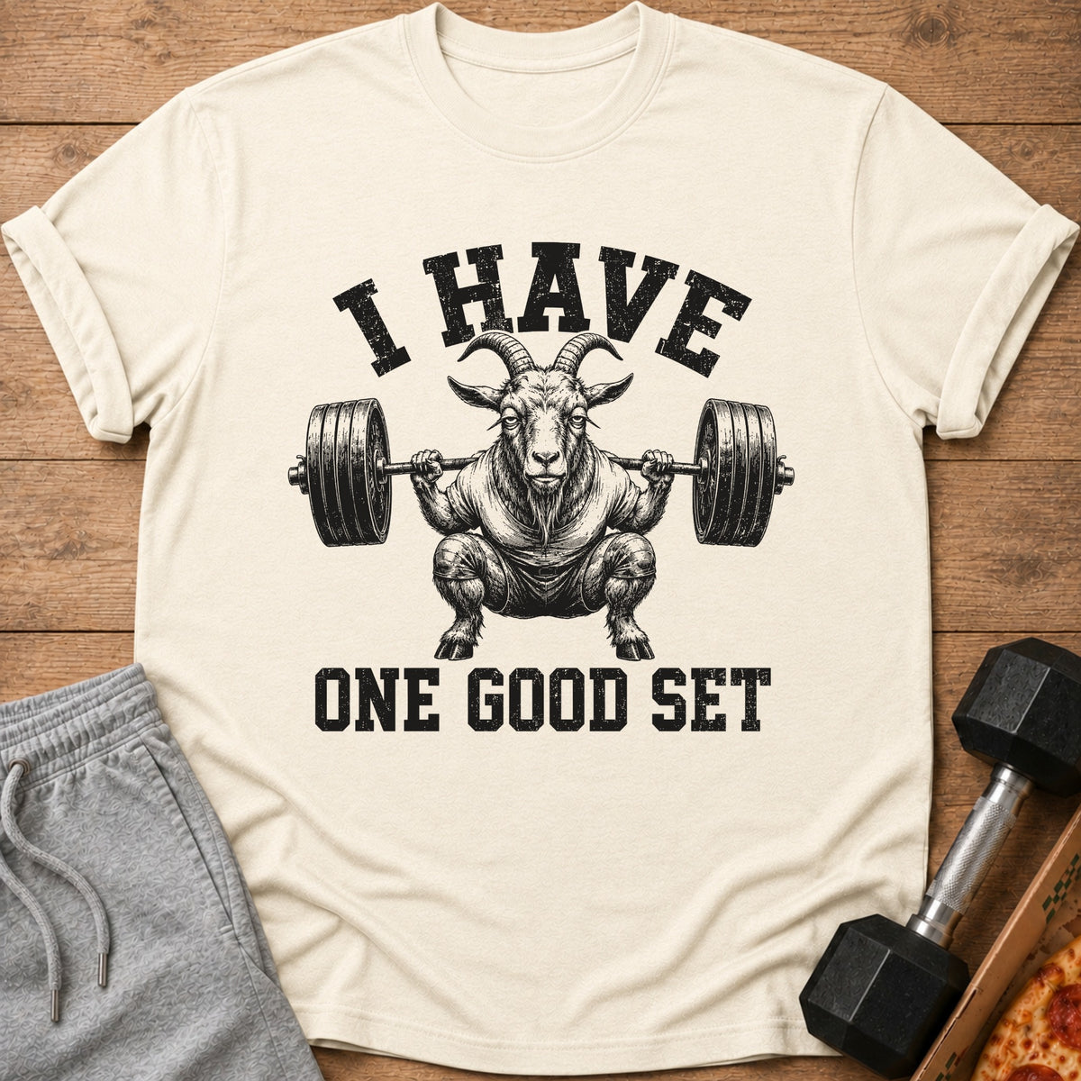 Cream t-shirt with goat lifting barbell and text "I HAVE ONE GOOD SET".