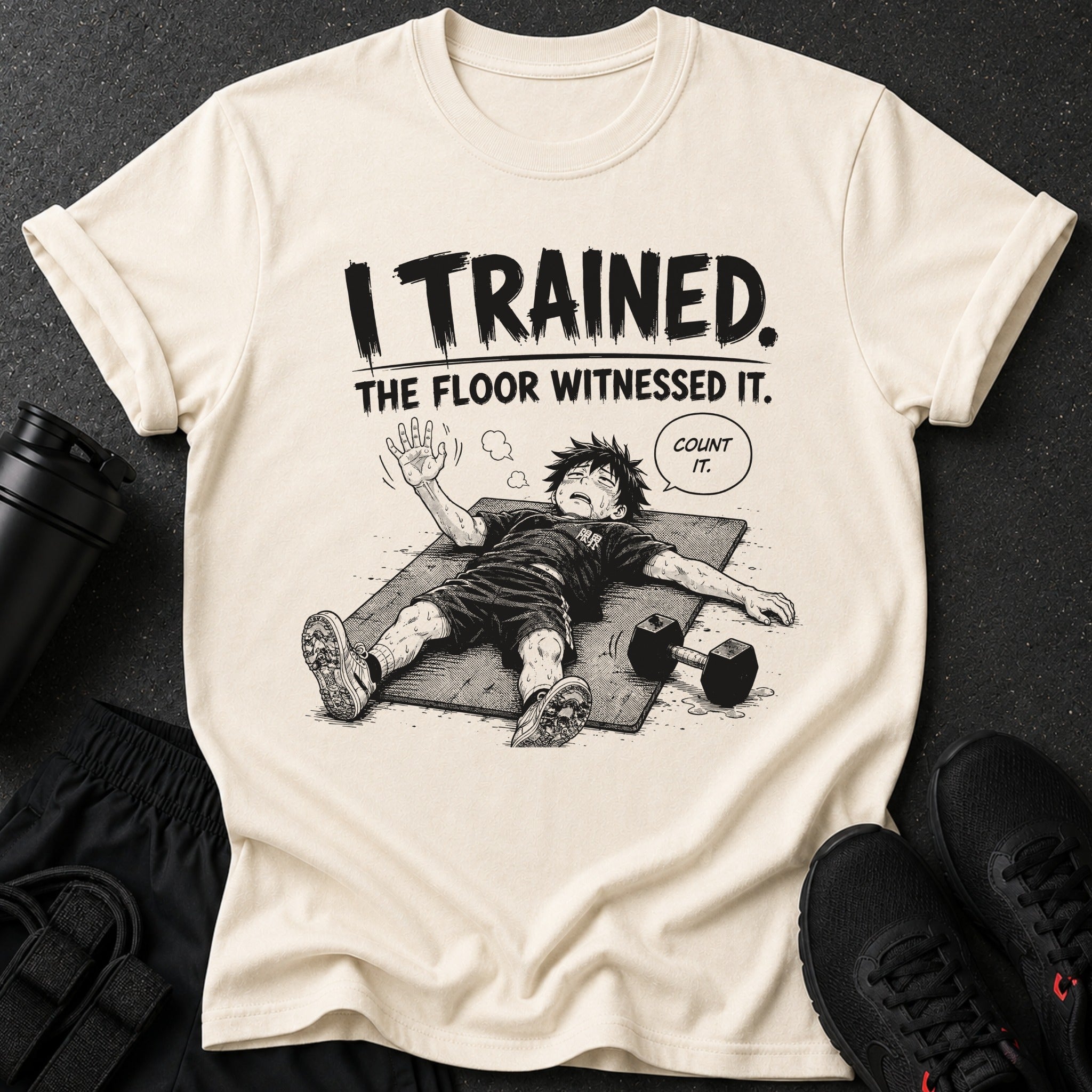 Shirt with "I TRAINED. THE FLOOR WITNESSED IT. COUNT IT." text and illustrated exhausted character.
