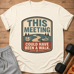 Cream t-shirt with "THIS MEETING COULD HAVE BEEN A WALK" graphic.