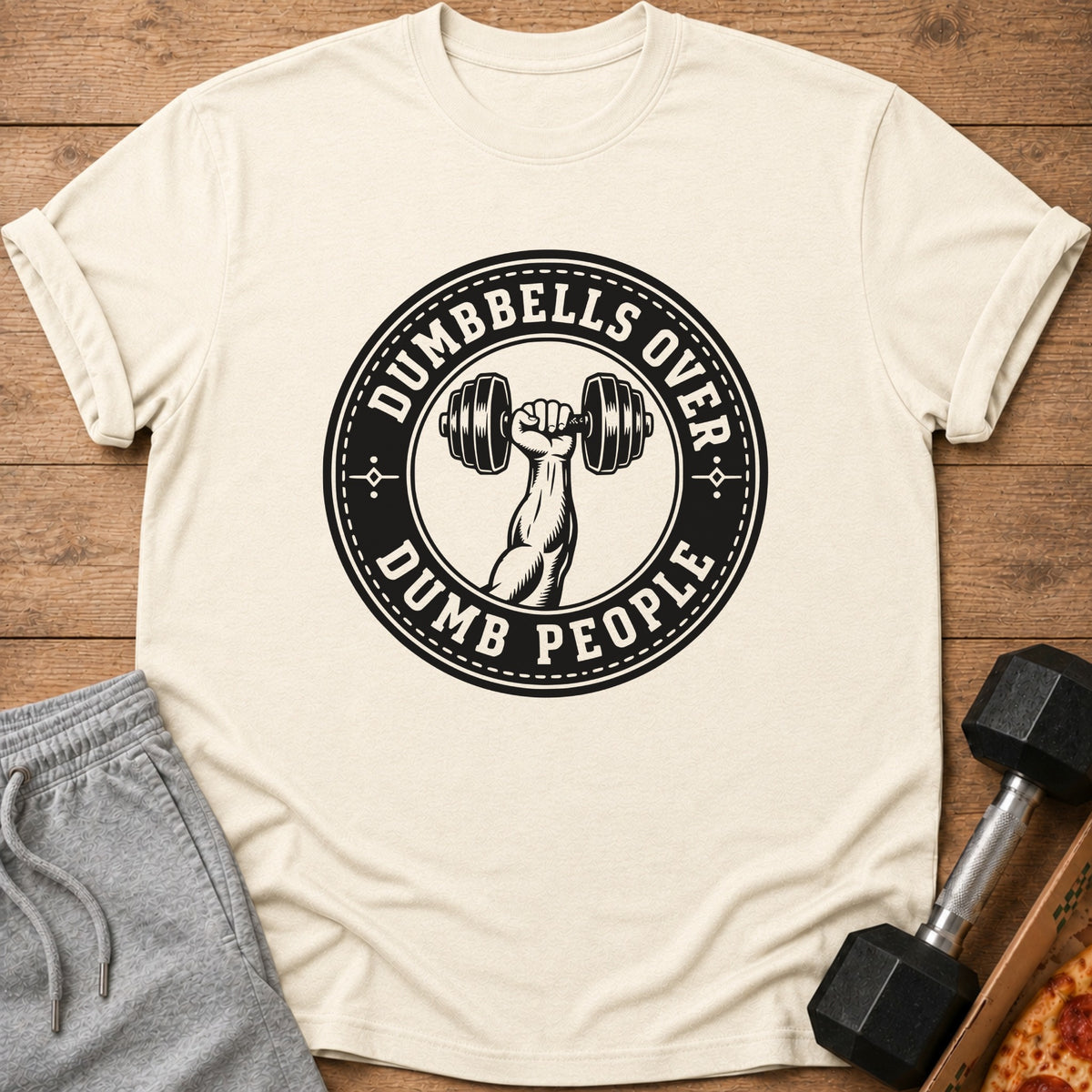 T-shirt with circular graphic reading "DUMBBELLS OVER DUMB PEOPLE" and arm holding dumbbell.