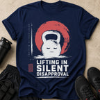 Navy t-shirt with a white kettlebell graphic and "LIFTING IN SILENT DISAPPROVAL" text.