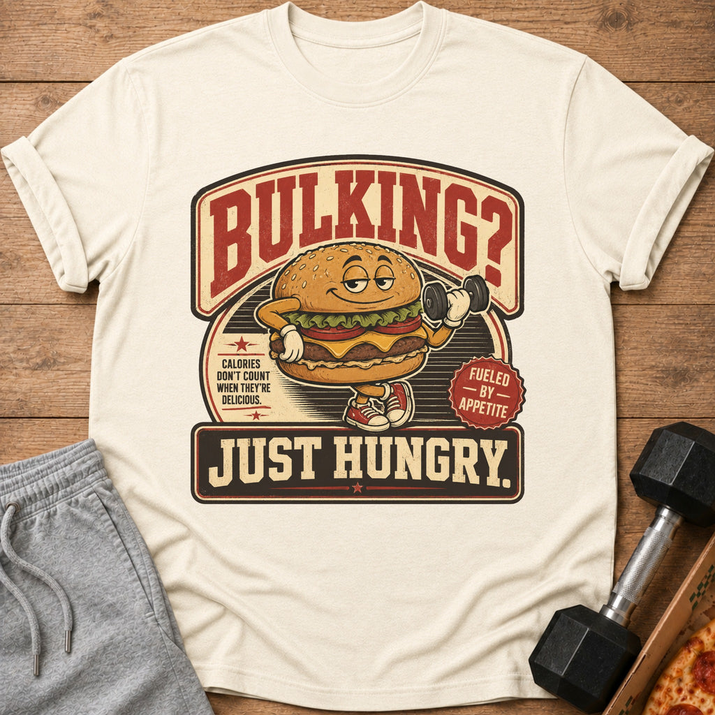 T-shirt graphic with a cartoon burger lifting weights and text "Bulking? Just Hungry."