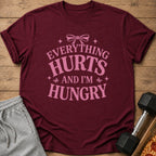 Maroon t-shirt with pink text "EVERYTHING HURTS AND I'M HUNGRY".