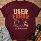 Maroon t-shirt with "USER ERROR" and treadmill graphic with sad person.