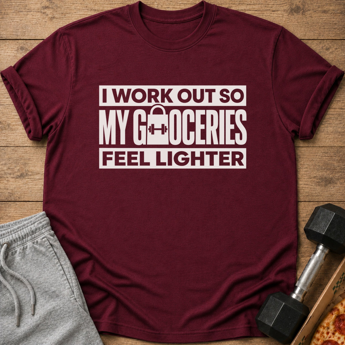 Maroon t-shirt with white text: "I WORK OUT SO MY GROCERIES FEEL LIGHTER".