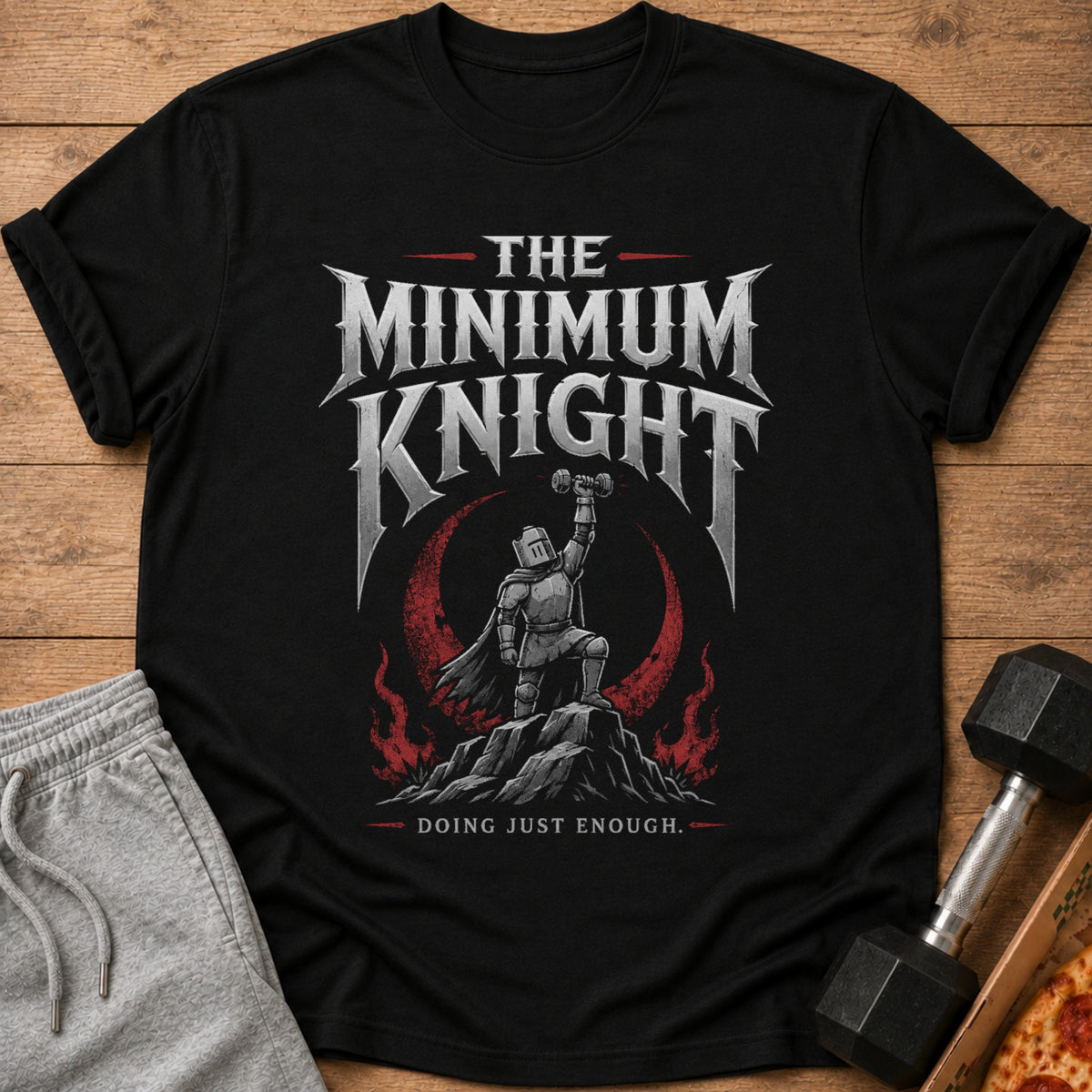 Black t-shirt graphic: knight raising dumbbell, text "The Minimum Knight Doing Just Enough."