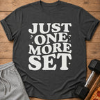 Dark grey t-shirt with white text reading "JUST ONE MORE SET".