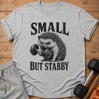 Grey t-shirt with text "SMALL BUT STABBY" and a hedgehog lifting a dumbbell.