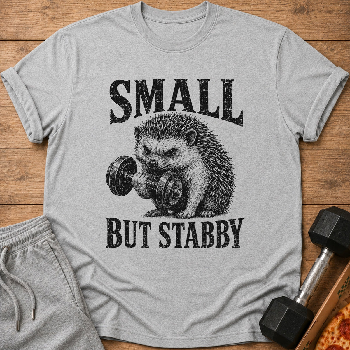Grey t-shirt with text "SMALL BUT STABBY" and a hedgehog lifting a dumbbell.