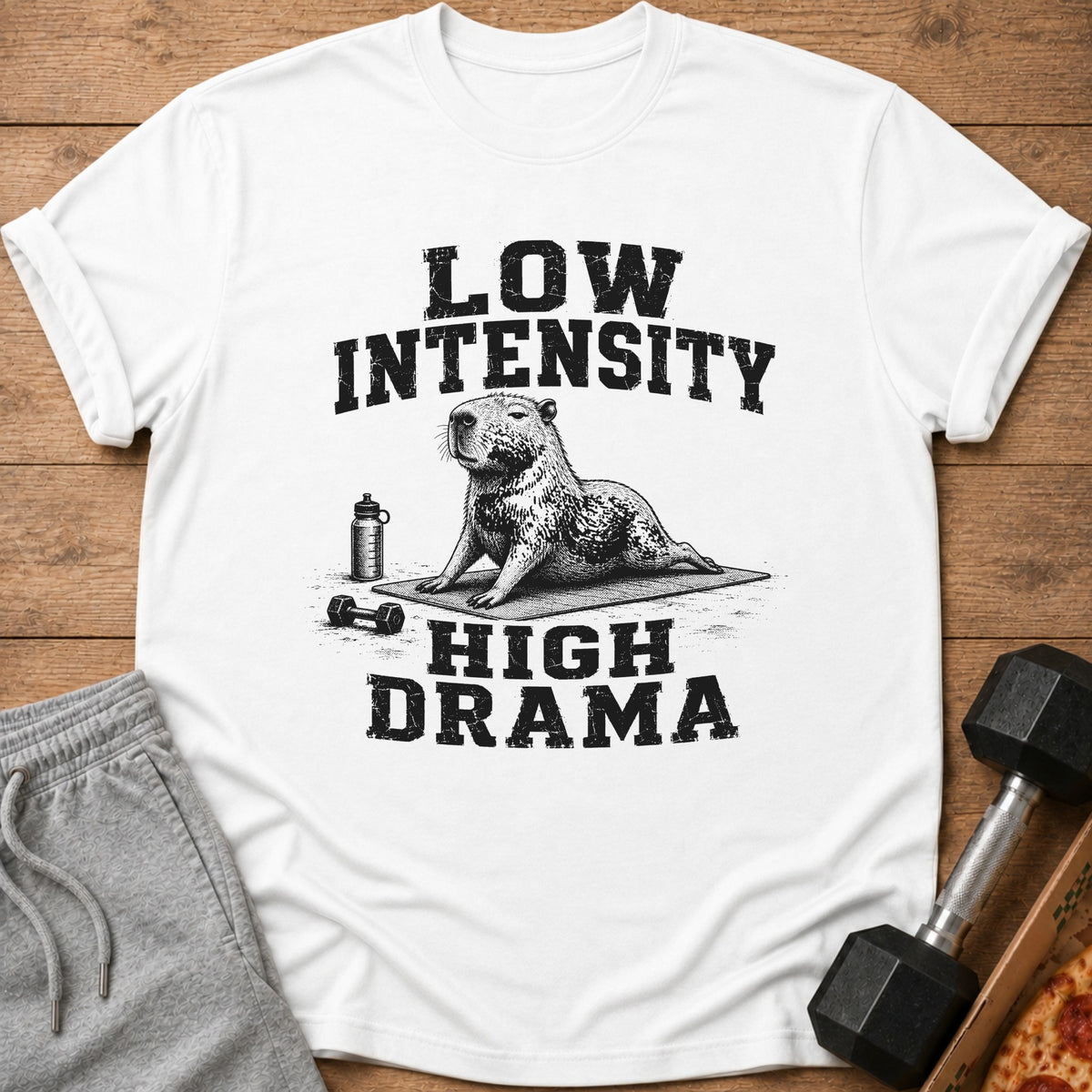 White t-shirt with text "Low Intensity High Drama" and a capybara doing yoga.