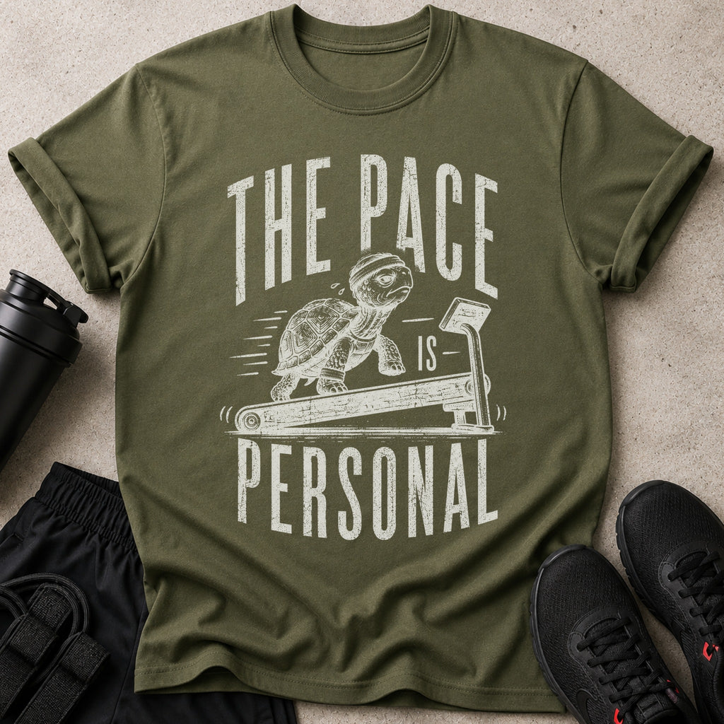 Olive t-shirt with graphic of turtle on treadmill; text reads "The Pace Is Personal".