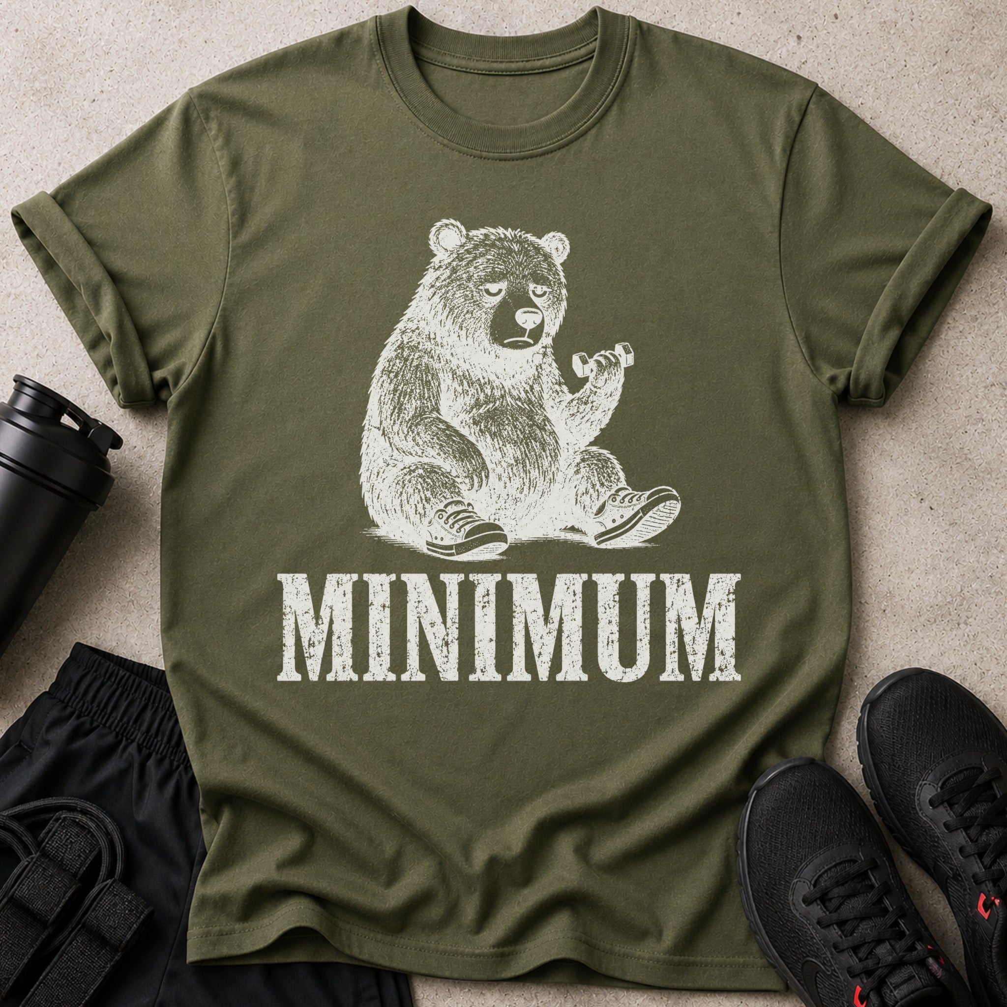 Green t-shirt with cream print of a bear holding dumbbell and text "MINIMUM".