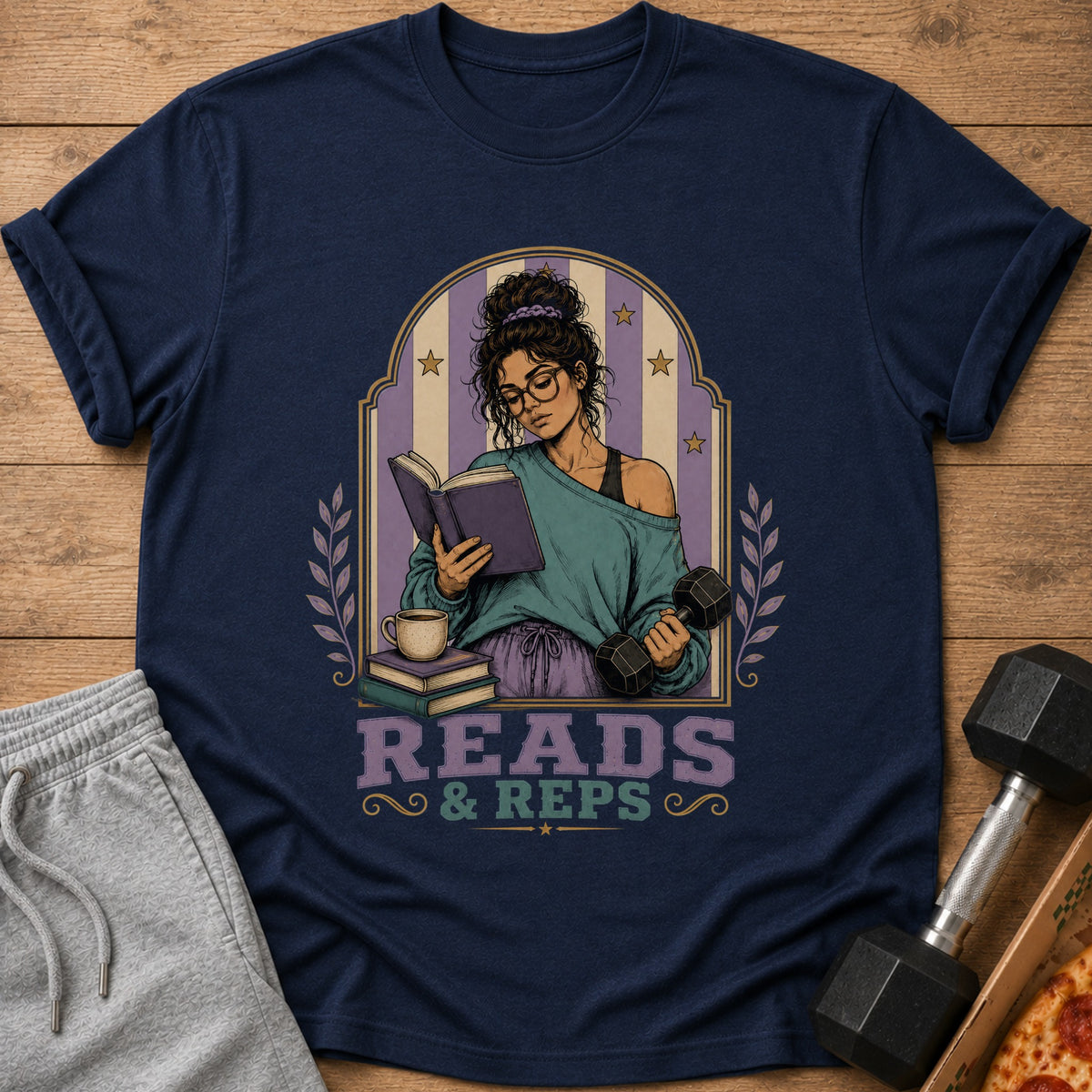 Navy t-shirt with illustration of woman reading and lifting weights, text "READS & REPS".